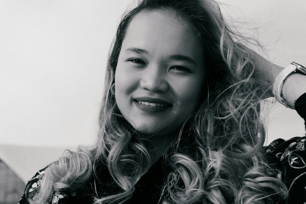 Portrait of a woman with long wavy hair smiling