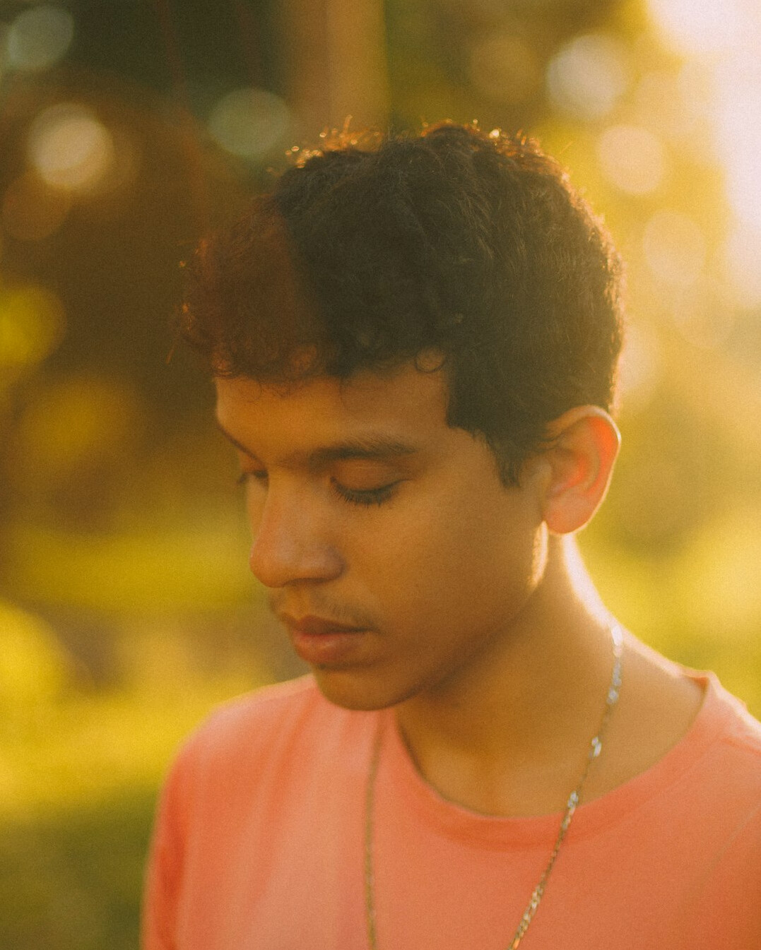 Portrait of a young man with short hair and a calm expression