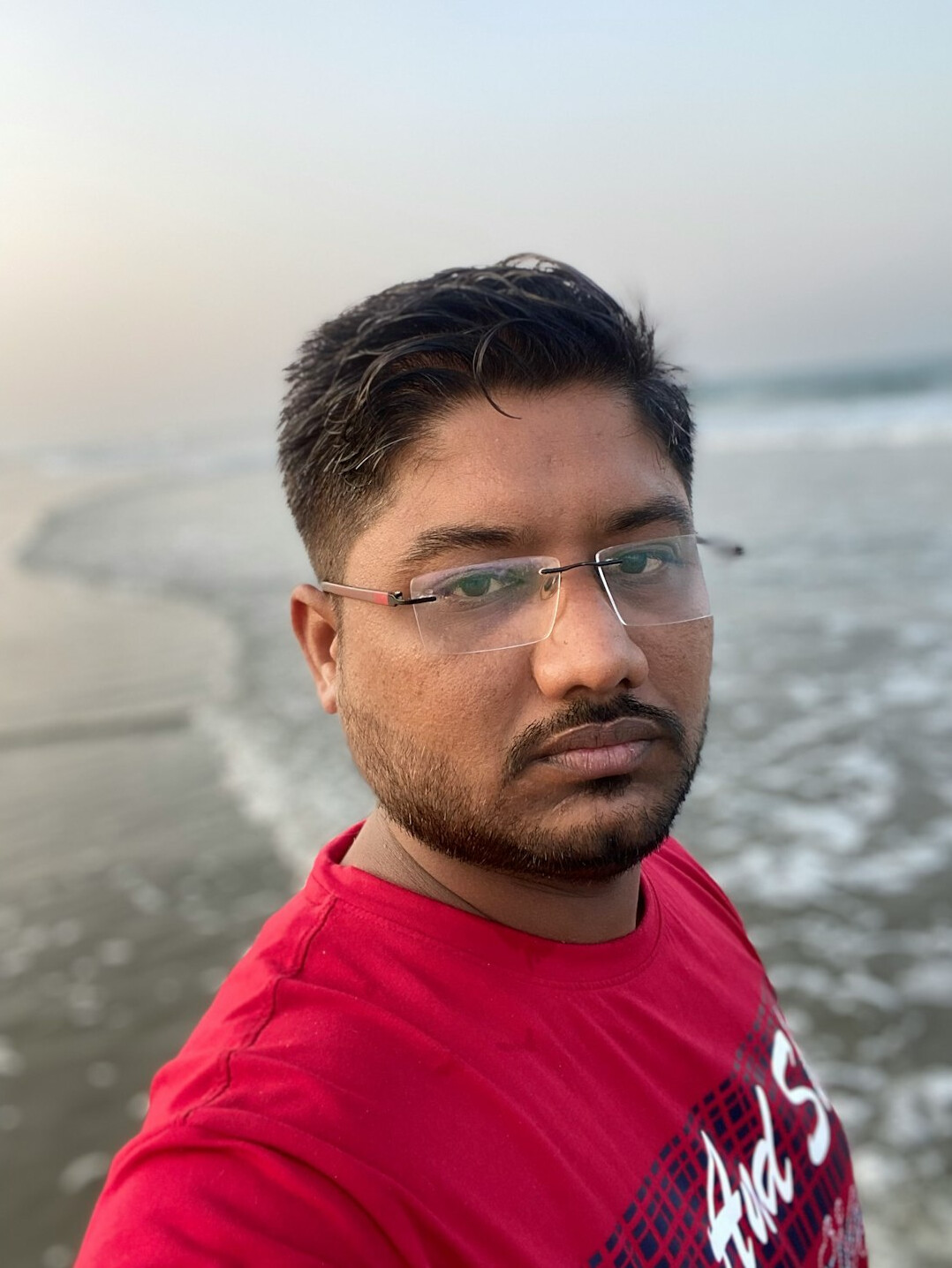 Portrait of a man with glasses and short beard